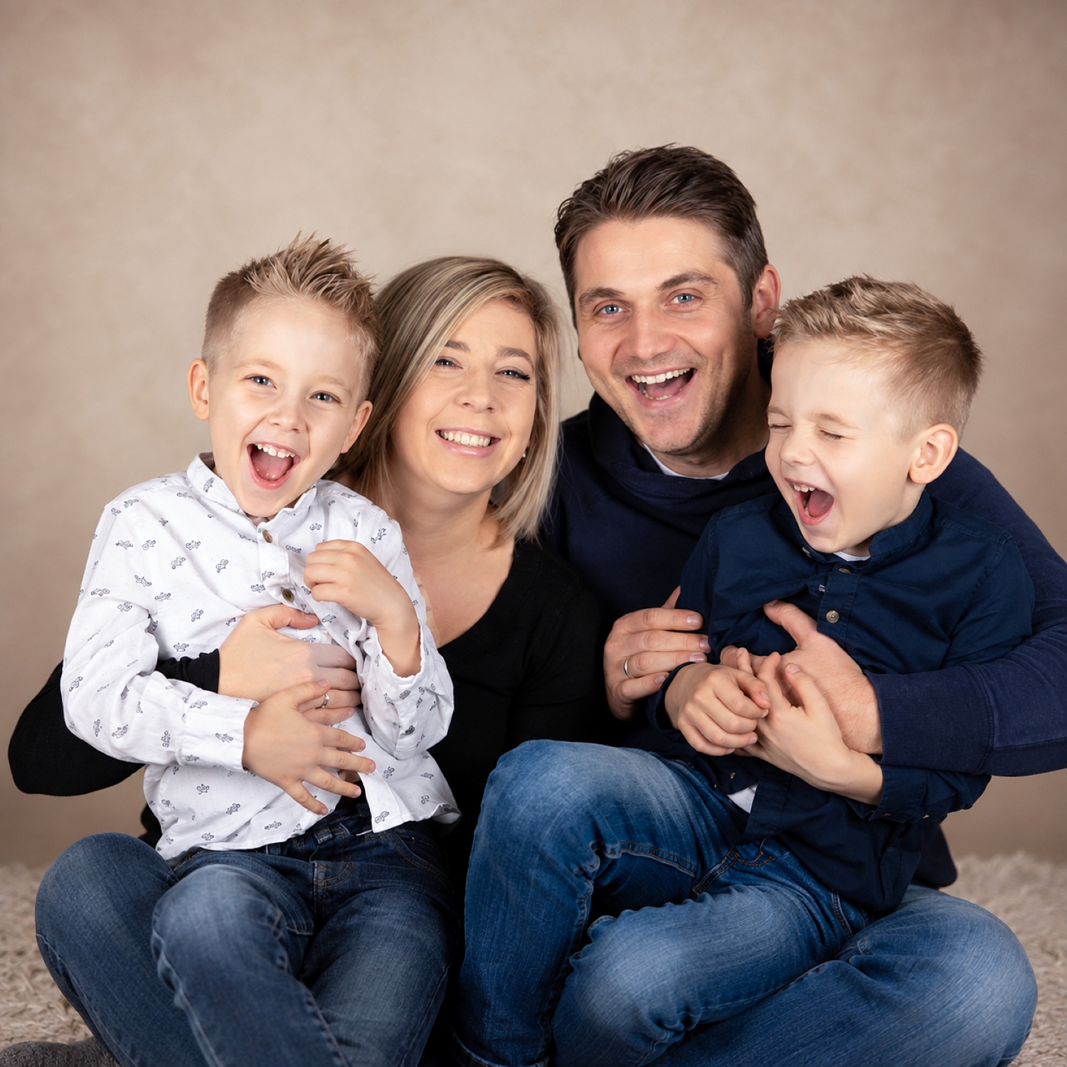 Fröhliche Familie mit zwei Kindern bei einem Fotoshooting im Fotostudio in Gensingen.